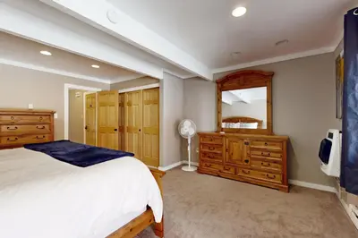 a bedroom with a bed and a dresser and a mirror at Alpine Serenity in Incline Village