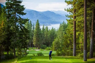 a man is playing golf on a golf course at Alpine Serenity in Incline Village
