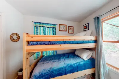 a bedroom with two bunk beds in a house at Under The Stars in Shaver Lake