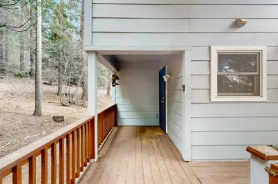 a porch with a blue door on a house at Under The Stars in Shaver Lake