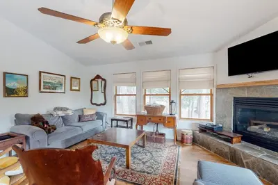 a living room with a couch and a ceiling fan at Under The Stars in Shaver Lake