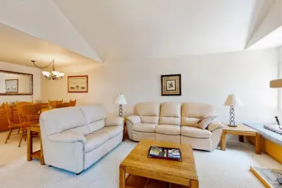 a living room with two white couches and a table at McCloud 176 in Incline Village