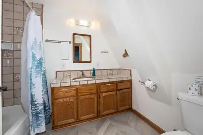 a bathroom with a sink and a toilet at Quail Haven- A-frame cabin with hot tub, views, and more in Oakhurst