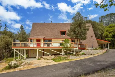 a house on the side of a road at Quail Haven- A-frame cabin with hot tub, views, and more in Oakhurst