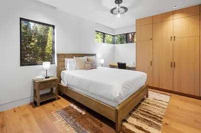 a bedroom with a large bed and a large window at Creekside Retreat - Near Palisades Tahoe in Olympic Valley