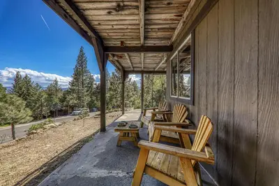 a porch with chairs and tables on a house at 4BR Tahoe Retreat in Prime Location in Tahoe City