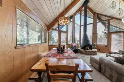 a living room with a wooden table and a fireplace at 4BR Tahoe Retreat in Prime Location in Tahoe City