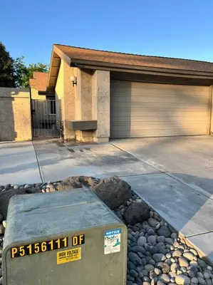 a house with a sign in front of a driveway at Remodeled Oasis in Visalia
