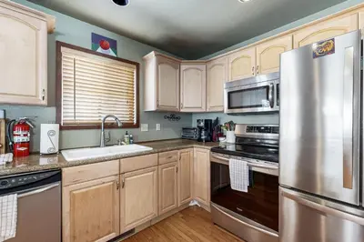 a kitchen with wooden cabinets and stainless steel appliances at Forest View in Soda Springs