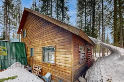 a log cabin in the woods in the snow at Forest View in Soda Springs