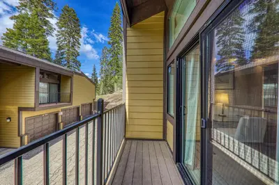 a balcony of a house with a glass door at 2BR Mins to Alpine Base Area Palisades! in Alpine Meadows