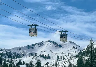 two gondolas on a ski lift over a snow covered mountain at 2BR Mins to Alpine Base Area Palisades! in Alpine Meadows