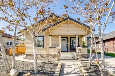 a house with a porch with trees in front at Walk to Midtown Charming Reno Retreat in Reno