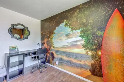 a room with a mural of the ocean and a surfboard at Family-Friendly Clovis Home with Gas Grill and Patio! in Clovis