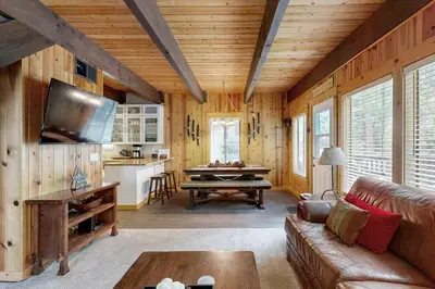a living room with a couch and a table at Tranquil Family Cabin in Incline Village