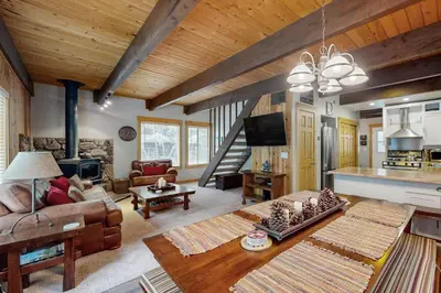 a living room with a couch and a table at Tranquil Family Cabin in Incline Village