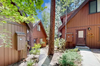 a house with a garage and a tree at Tranquil Family Cabin in Incline Village