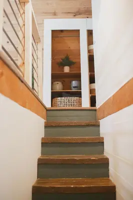 a staircase in a house with wooden walls and floors at Redwood Grove in Sequoia and Kings Canyon National Park in Wilsonia