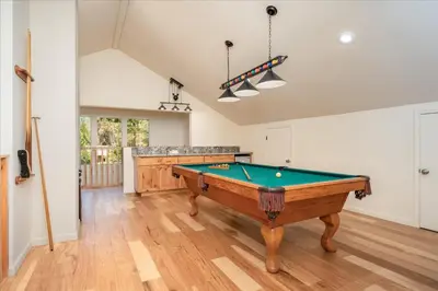 a living room with a pool table in it at Base Camp- Inside Yose w pool table/grill in North Wawona