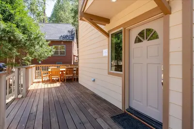 a front door of a house with a deck at Base Camp- Inside Yose w pool table/grill in North Wawona