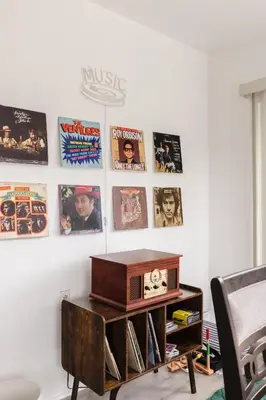 a room with a radio and posters on the wall at Homey Pool Fun Gameroom Sunnyside Retreat in Fresno