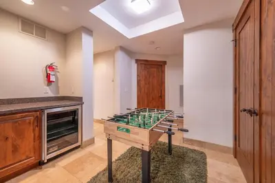 a kitchen with a table with a glass counter top at Luxury Northstar Home Walk to Lifts Private Hot-Tub Fenced-In Yard Book on Mobile for Promo Price in Truckee