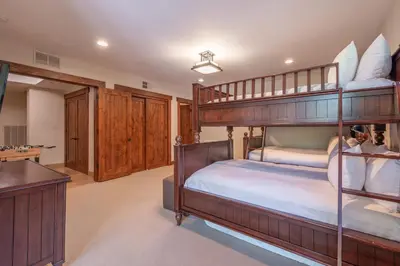 a bedroom with two bunk beds and a desk at Luxury Northstar Home Walk to Lifts Private Hot-Tub Fenced-In Yard Book on Mobile for Promo Price in Truckee