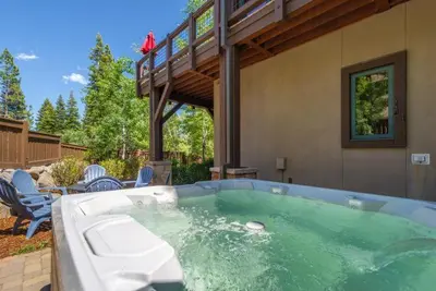 a hot tub in a yard with chairs and a house at Luxury Northstar Home Walk to Lifts Private Hot-Tub Fenced-In Yard Book on Mobile for Promo Price in Truckee