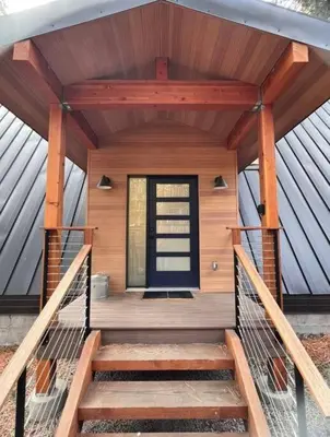 a front porch of a wooden house with a door at Brand New Modern A-Frame In Kings Beach Two Blocks From The Beach in Kings Beach