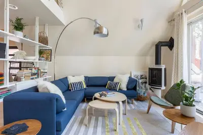 a living room with a blue couch and a table at Brand New Modern A-Frame In Kings Beach Two Blocks From The Beach in Kings Beach