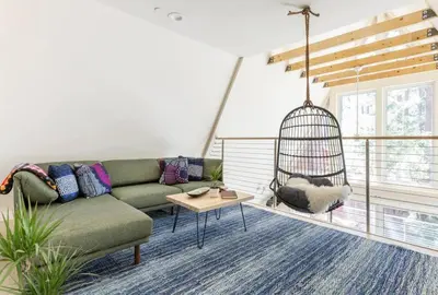 a living room with a couch and a swing at Brand New Modern A-Frame In Kings Beach Two Blocks From The Beach in Kings Beach