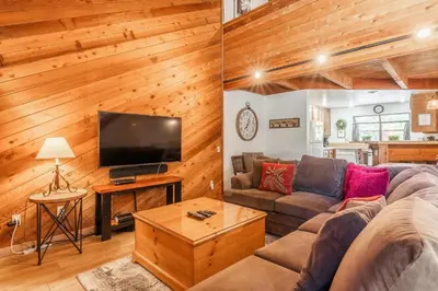 a living room with a couch and a tv at Snowflower #79 - Updated 2 Bedroom & Loft, 3 Bath, Sleeps 8, Steps away from Free Town Shuttle in Mammoth Lakes