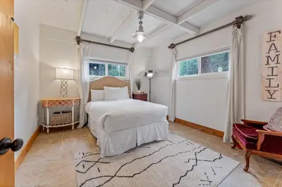 a bedroom with a white bed and a large window at 5BR A Frame Near Patton Beach with 2 Decks in Carnelian Bay