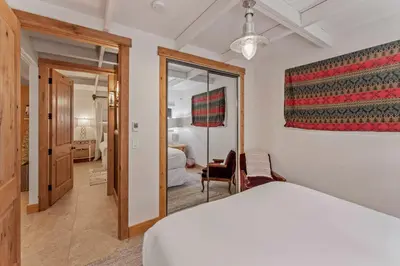 a bedroom with a white bed and a mirror at 5BR A Frame Near Patton Beach with 2 Decks in Carnelian Bay