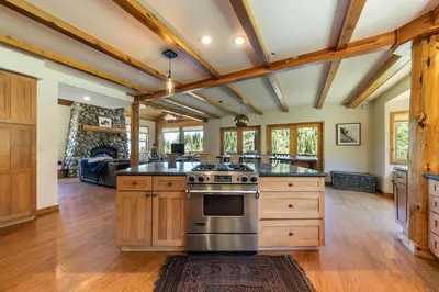 an open kitchen with wooden cabinets and stainless steel appliances at Horizon at Tahoe Donner w Private Hot Tub and Mountain Views in Truckee