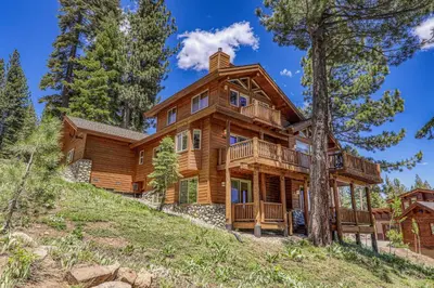 a log home on a hill with trees at Horizon at Tahoe Donner w Private Hot Tub and Mountain Views in Truckee