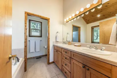a bathroom with two sinks and a large mirror at Horizon at Tahoe Donner w Private Hot Tub and Mountain Views in Truckee