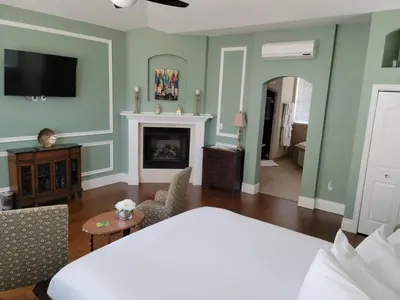 a living room with a bed and a fireplace at The Inn at 161 in Sutter Creek