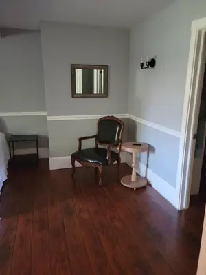 a room with a chair and a table at The Inn at 161 in Sutter Creek