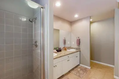 a bathroom with two sinks and a shower at Creekside & Cozy in Bass Lake