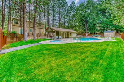 a yard with a house and a swimming pool at Creekside & Cozy in Bass Lake
