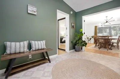 a living room with a bench and a table at Home in the Pines - Apple Hill - Dog Friendly - Snow Nearby in Pollock Pines