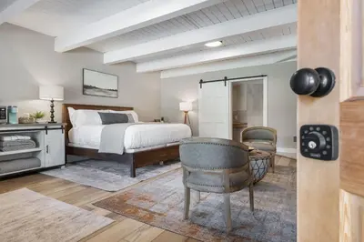 a bedroom with a bed and a table and chairs at Big Pine Suite CN Lodge R#1 in Ponderosa