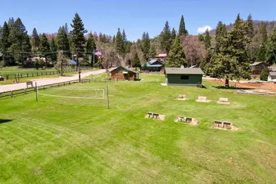 a park with benches in the middle of a field at Camp Nelson Lodge Room 2 in Ponderosa