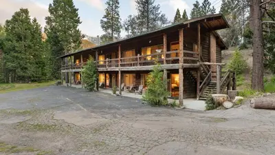 a large log house in the woods at Suite Meadow @CN Lodge# 7 in Ponderosa