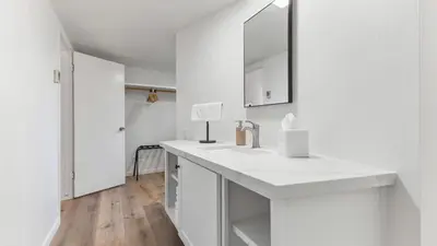 a white bathroom with a sink and a mirror at Camp Nelson Lodge Room 6 in Ponderosa