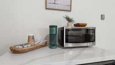 a microwave sitting on top of a kitchen counter at Camp Nelson Lodge Room 6 in Ponderosa