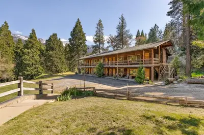 a home in the woods with a fence at Timberline Retreat CN Lodge #3 in Ponderosa