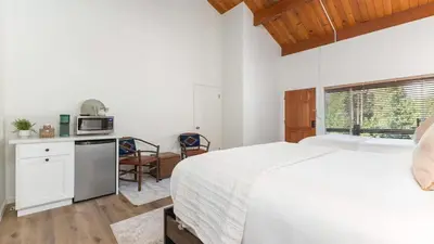 a bedroom with a bed and a kitchen with a microwave at Sierra Vista @CN Lodge #8 in Ponderosa