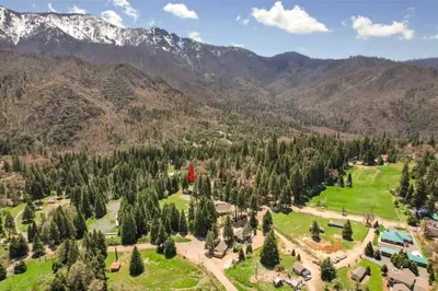 an aerial view of a resort with mountains in the background at Camp Nelson Lodge Room 9 in Ponderosa